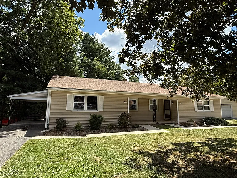 Duplex includes carport. Lovely setting.