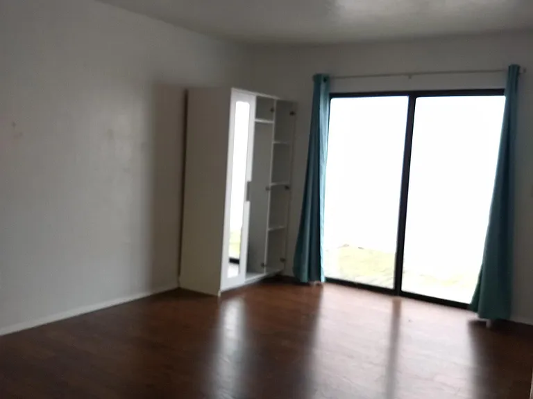 Master bedroom with sliding glass door to private side deck