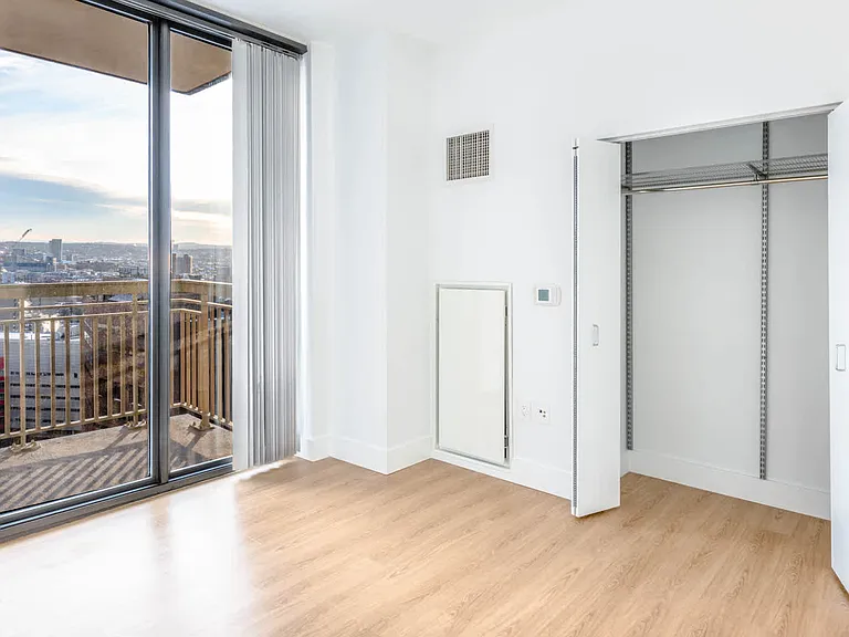 Bedroom with Balcony and Hardwood Flooring