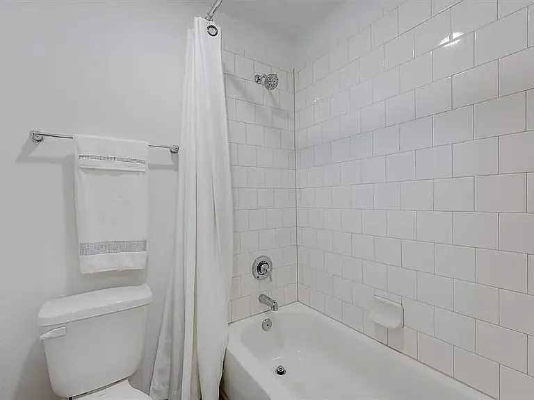 The upstairs bathroom tub/shower with full tile