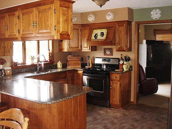 Spacious kitchen is fully equipped with silestone countertops & appliances.