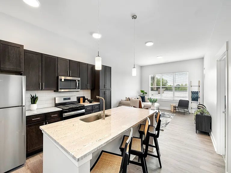 Open-plan kitchen with island and breakfast bar seating