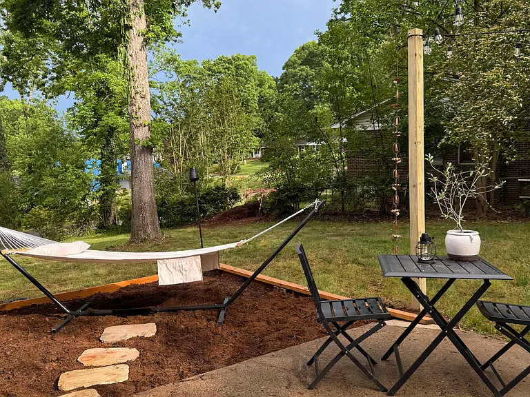 Backyard - patio bistro set, hammock, large grassy area shaded with mature oak trees. Partially fenced.