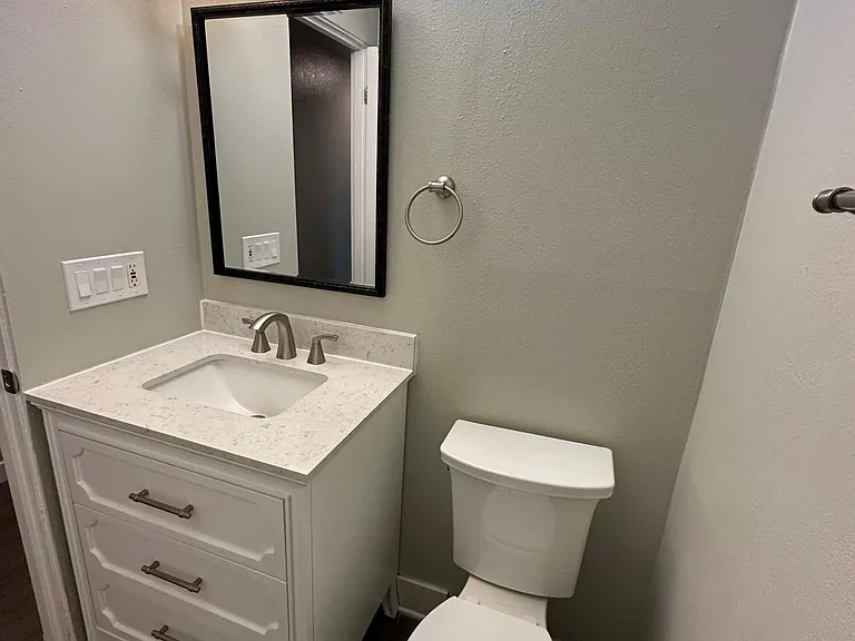 Bathroom 2 in the hallway of the unit with full-size bathtub