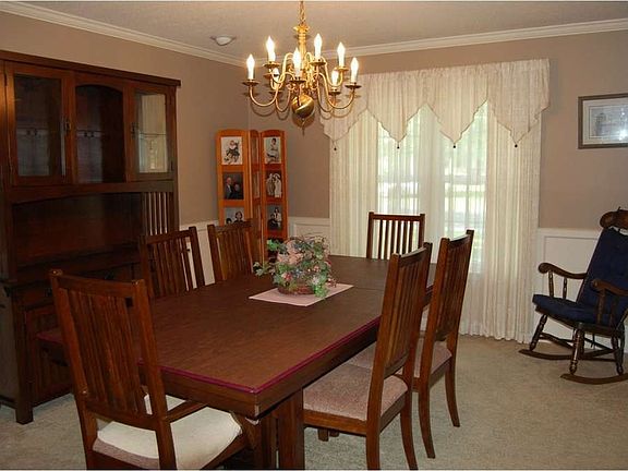 "Lovely waisncoting defines the formal dining room"