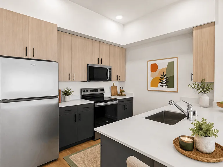 Modern 2-bedroom apartment kitchen with quartz countertops, stainless-steel appliances, and contemporary finishes at 27 West Apartments.