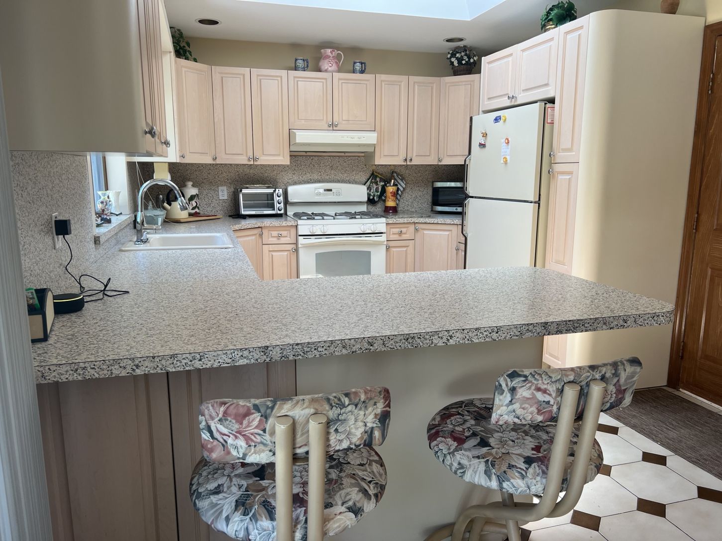 The well-equipped kitchen opens to the dining and living rooms.