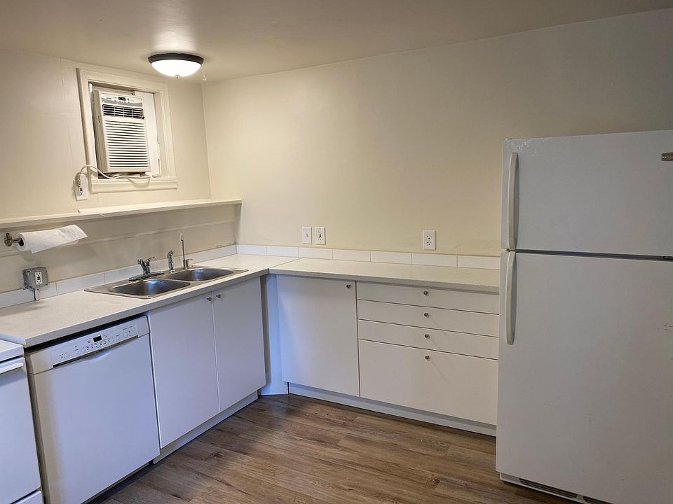Kitchen, with dishwasher and refrigerator, and A/C unit.
