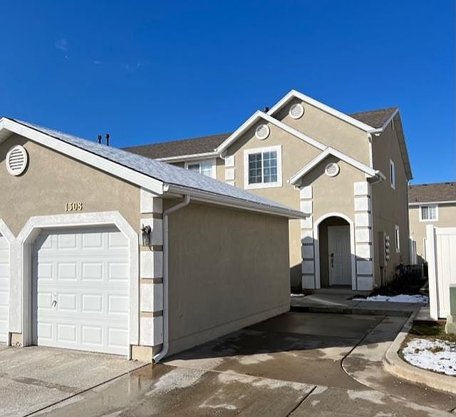 Light and bright row end unit. One car garage with lots of shelving and dedicated one car parking spot.