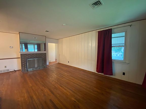 Living Room with Hardwood Flooring & Wood Burning Fireplace
