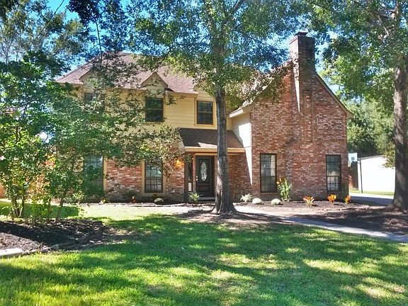 Shaded by large trees in front. fresh landscaping and lush lawn.