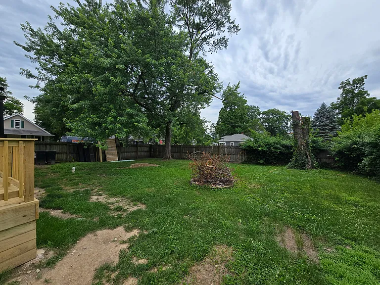 Fully fenced backyard with firepit