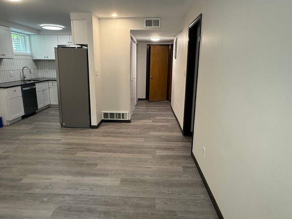 view of entry on right, private laundry next to entry, kitchen on left, living room