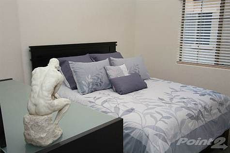 Second Bedroom with Queen Bed and Dresser and Mirror