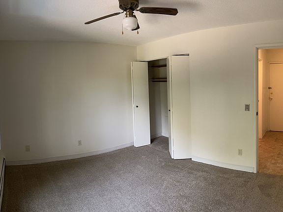 The bedroom has an oversized window, linen closet, and ceiling fan.
