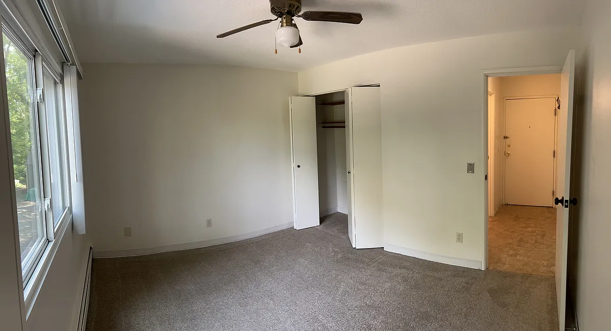 The bedroom has an oversized window, linen closet, and ceiling fan. - 1100 18th Ave SE #2