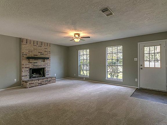 Brick fireplace anchors this large living room!