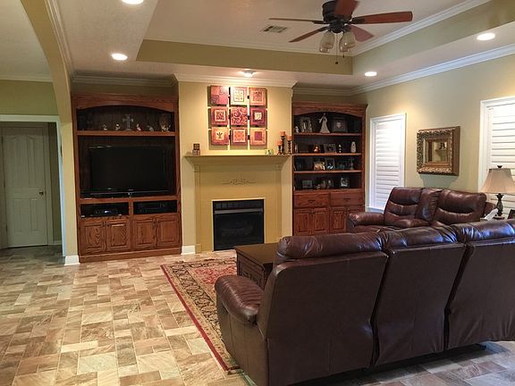 Living Room
						:
						Built in cabinets, plantation shades