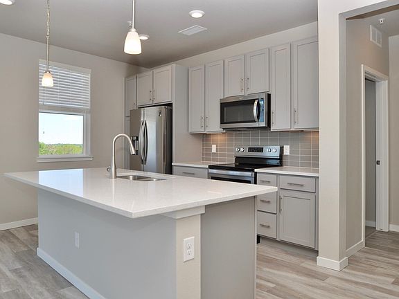 Kitchen with hallway leading to master bedroom