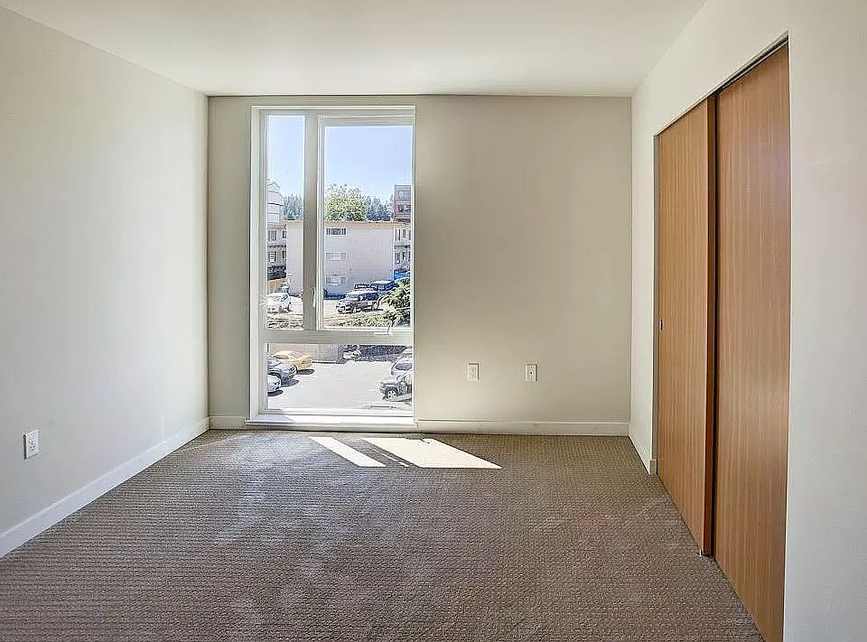 Bedroom with brand new carpet, floor to ceiling windows, and large closet for plenty of storage