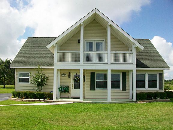  TWO STORY VINYL SIDING, W/DOUBLE PANE WINDOWS, COVERED FRONT PORCH & BALCONY