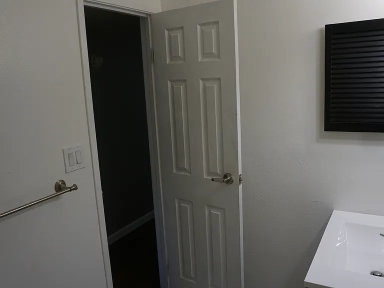 Full bathroom is off the main hallway near the living room.