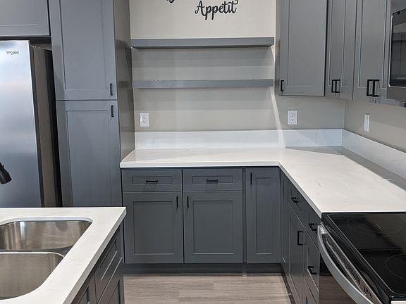 Kitchen with refrigerator, dishwasher, microwave, & disposal.