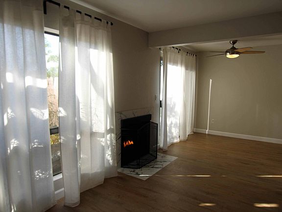 Living room and dining area, showing fireplace.