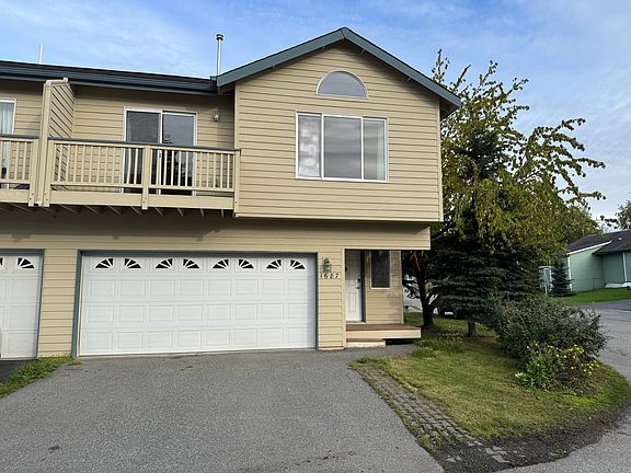 Front of house, townhouse style duplex with balcony