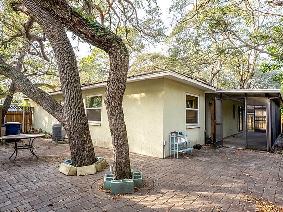 Back of the house, view of the screened in porch.