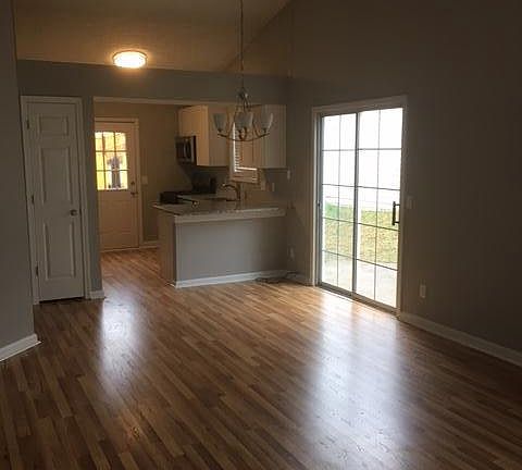 Great room with new hardwood type flooring with view to kitc
