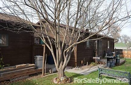 back yard with deck off the dinning/kitchen. Tree is a non producing apple tree.