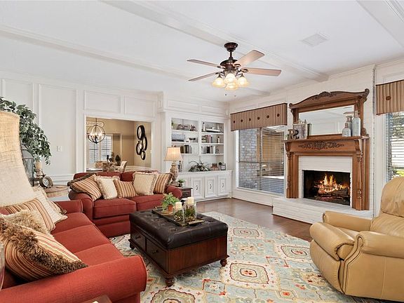 Upon entering the family room, you notice the exquisite wood flooring continues and the extensive woodwork including the built-ins! There are so many fine details in this pristine home.