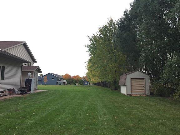 Tree lined yard and convenient storage shed.