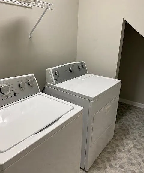 Storage area under stairs in laundry room.