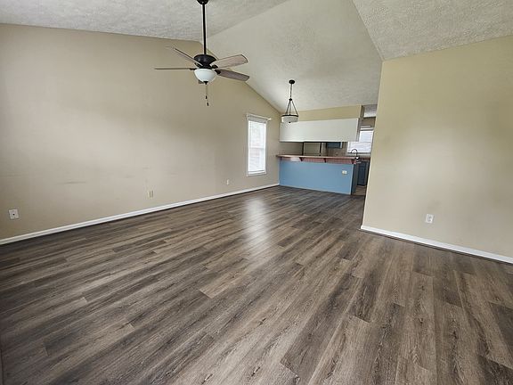 Front entryway leads into large shared living & dining room with vaulted ceiling.
