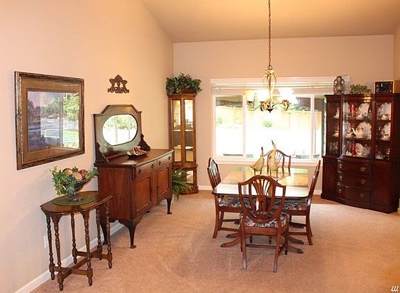 Spacious, vaulted dining room with view of the rear yard.