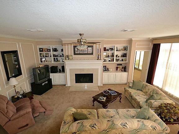 Den w/ Gas Log Fireplace, Built-Ins and Fan.