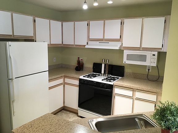 Open kitchen with a breakfast bar and built in microwave