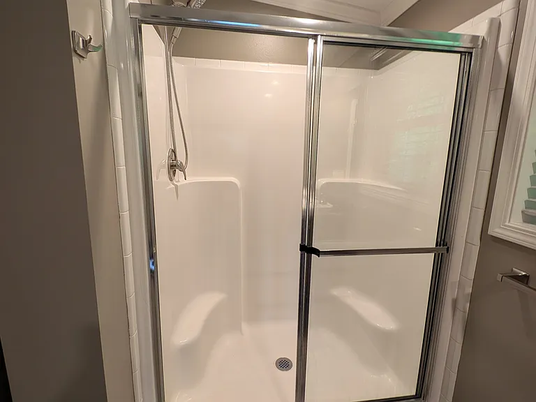 Oversized shower with seat and glass door