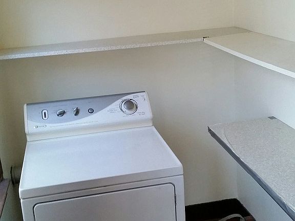 Pantry with plenty of shelves and Maytag Dryer