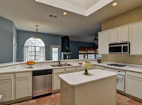 Spacious Island Kitchen w Skylight is Open to Family Room.
