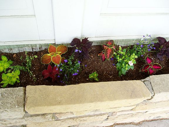 Built-in front flower box provides color, accent as you walk in