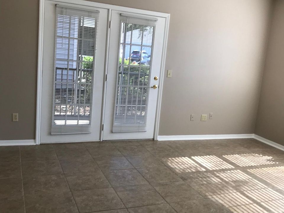 Living room with french doors leading to screen in porch