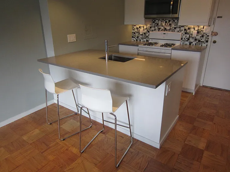 OPEN KITCHEN WITH STONE COUNTERTOP & BAR WITH STOOLS