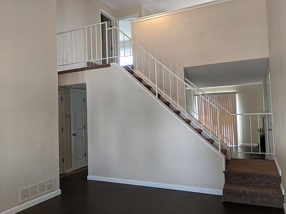 Living Room and view of Upstairs. Easy care tile floors new 3 years ago.