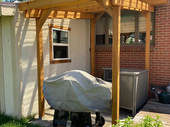 Pergola covering Weber grill and electric smoker.