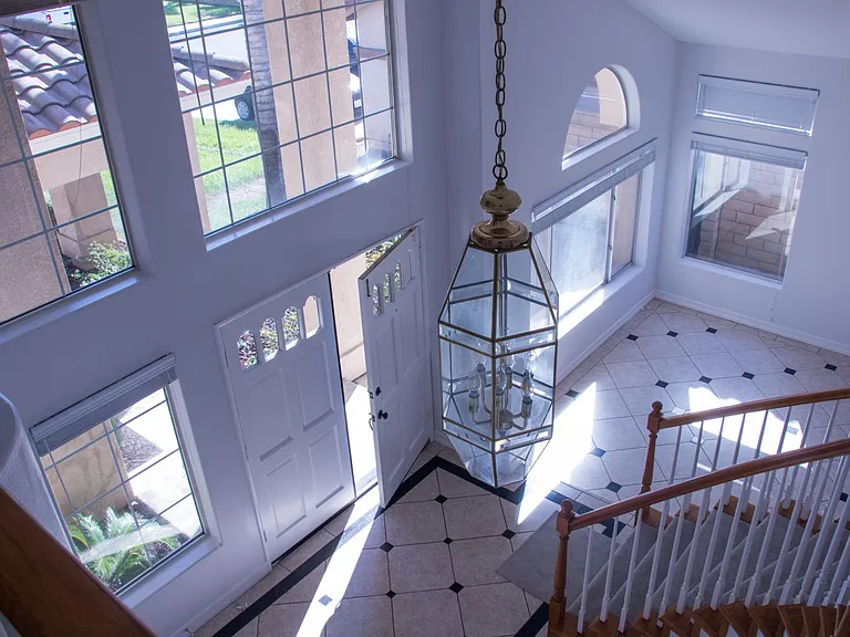 Bird's eye view of the front entrance, family room and stairs.
