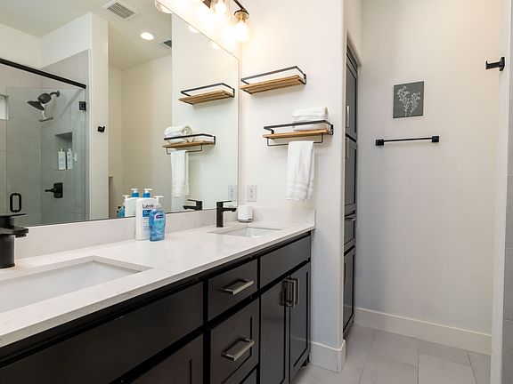 Primary full bathroom - double sinks and counter space.