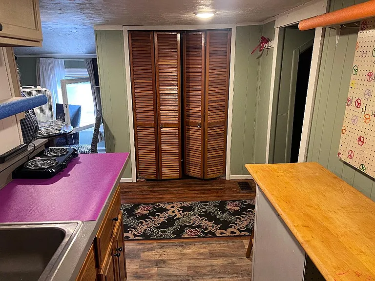 2nd floor kitchen with small fridge, microwave, small electric oven and dual burner cook top. There is not a full size oven.